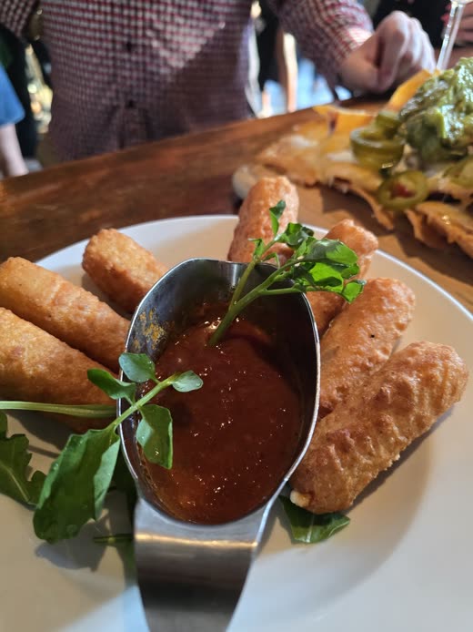Golden mozzarella sticks with a ramekin of marinara