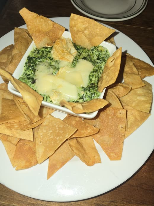 Baked spinach and artichoke dip ringed with tortilla chips